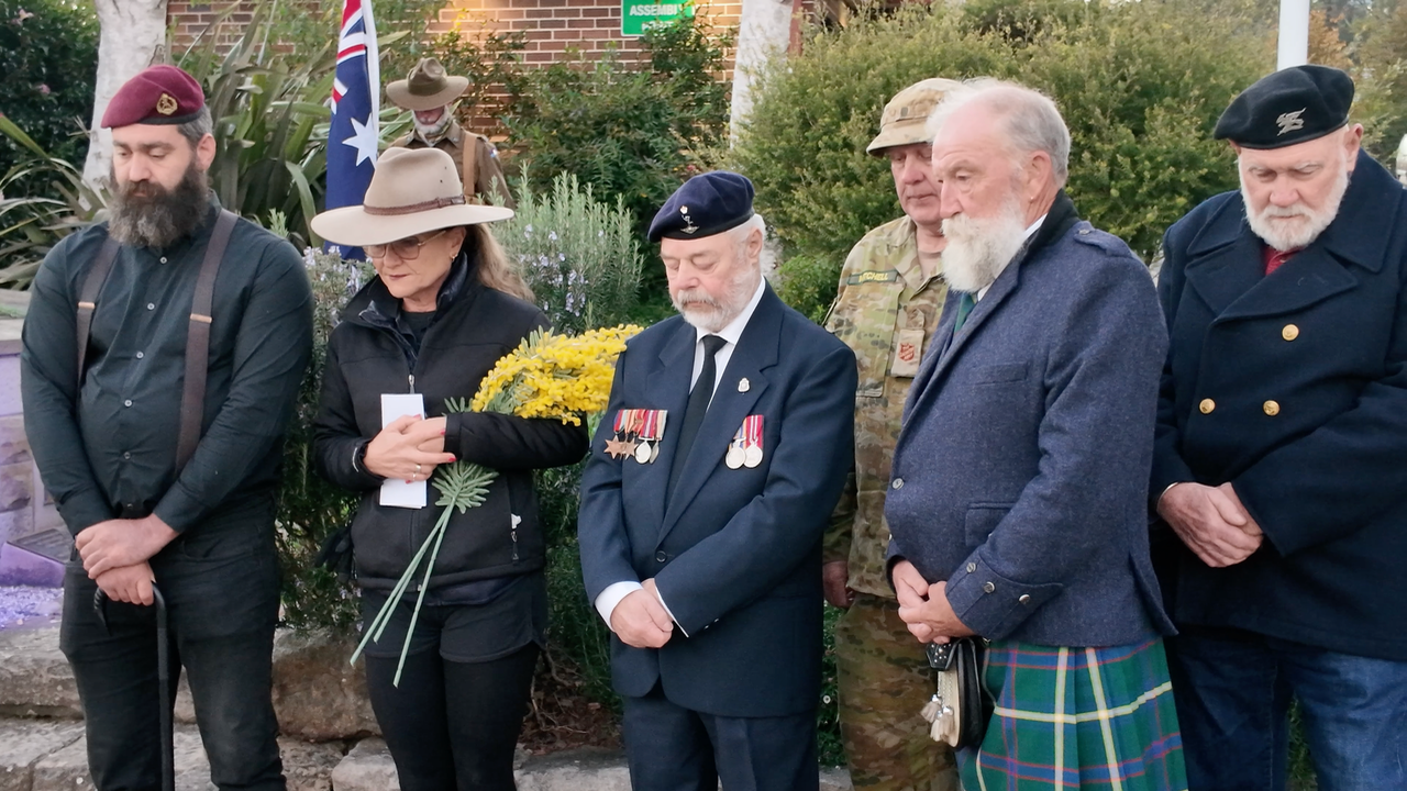 Veterans and supporters gather at a wreath-laying ceremony at the conclusion of the Unknown Veteran March 2026