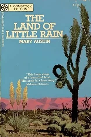 The cover of The Land of Little Rain by Mary Austin. It shows an illustration of a cactus, some desert flowers and a rocky outcrop in the background.