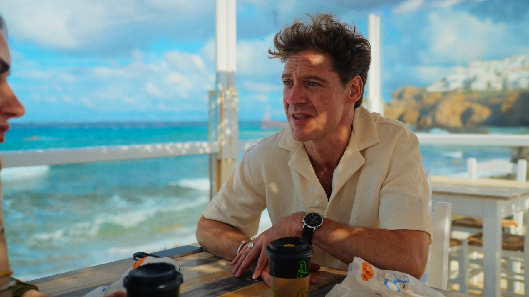 A man at a waterfront café in NAXOS.