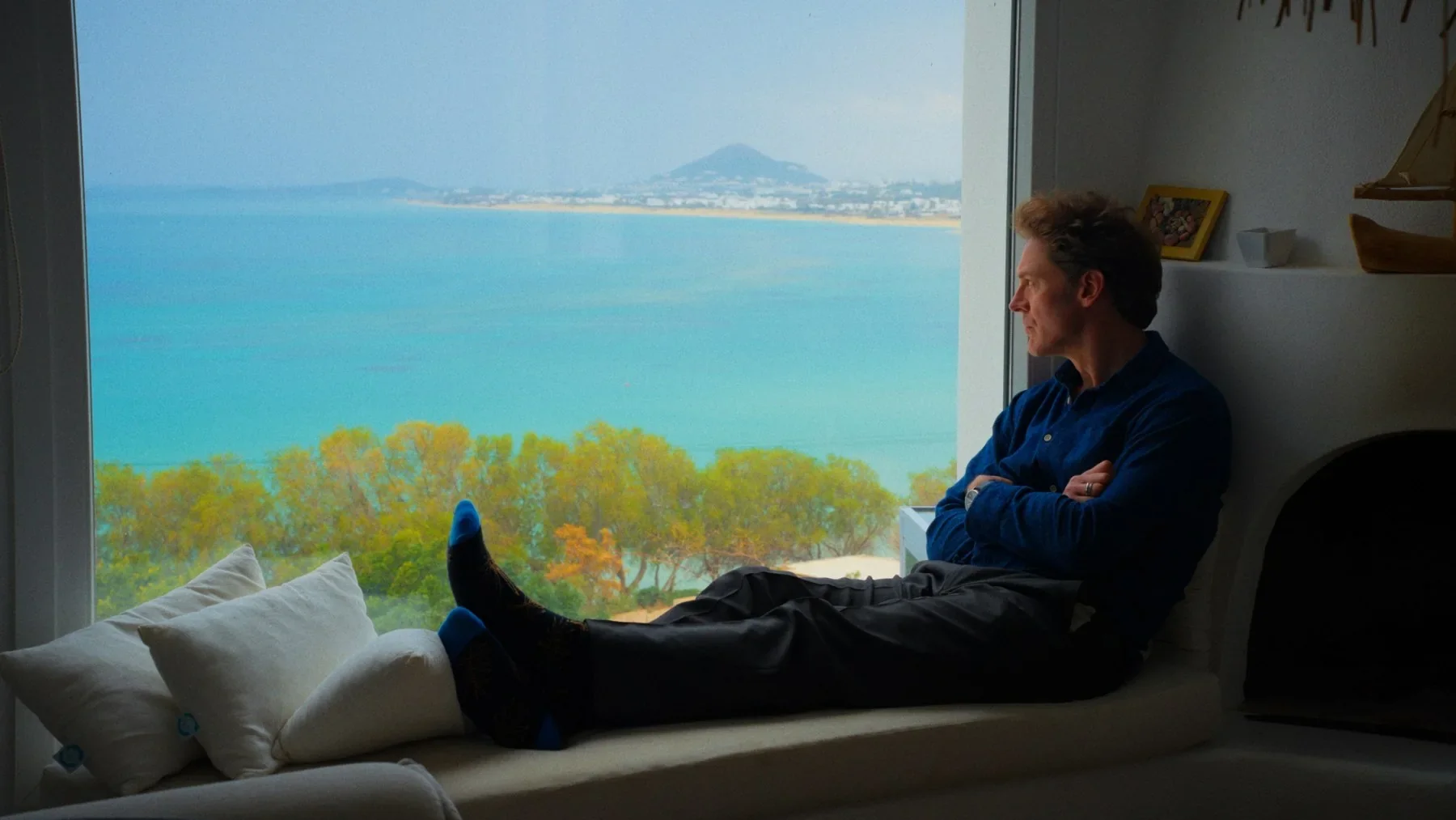 A figure in a room overlooking the sea in NAXOS.