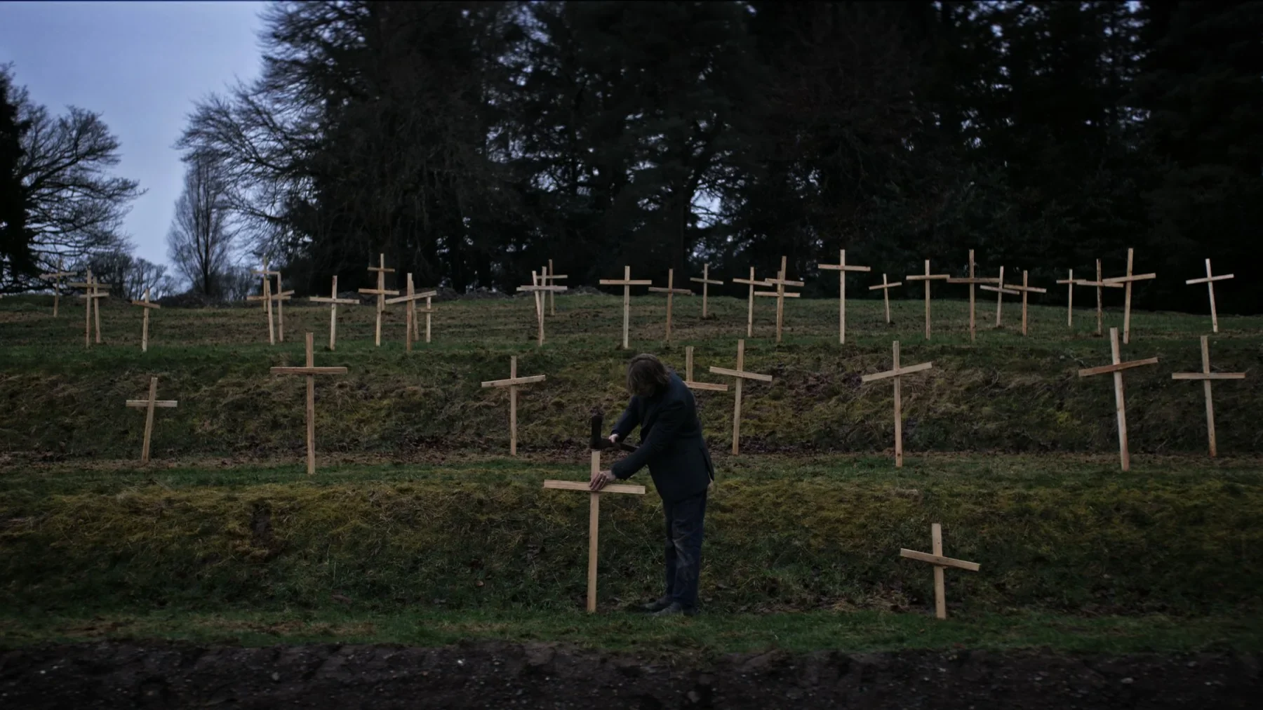 A figure among gravestones in An Taibhse.