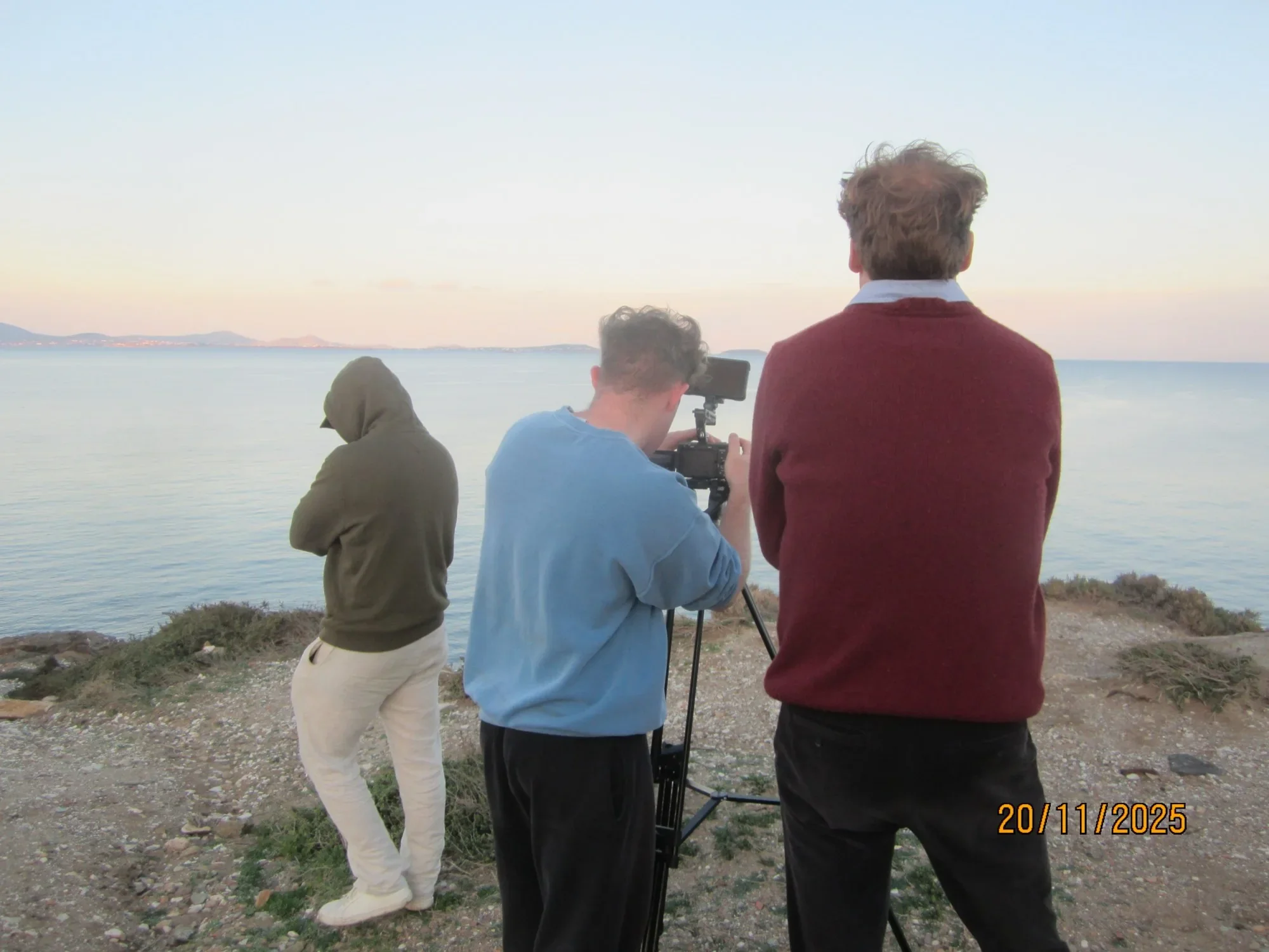 The NAXOS team filming by the sea at sunset.