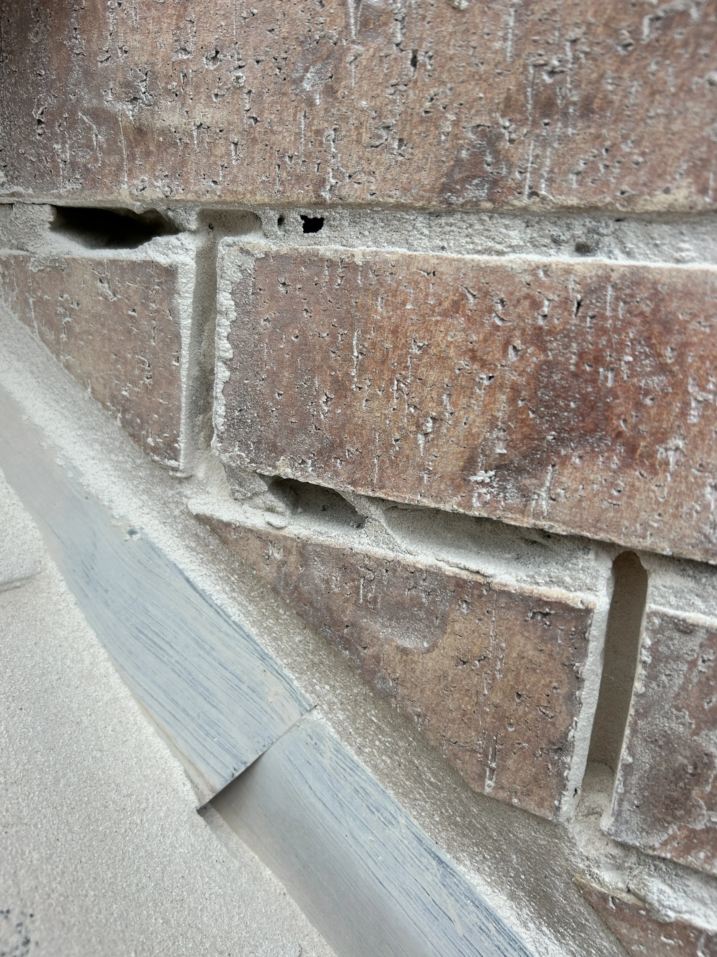 Failed mortar joints before grinding and repointing on a Southlake Texas brick home
