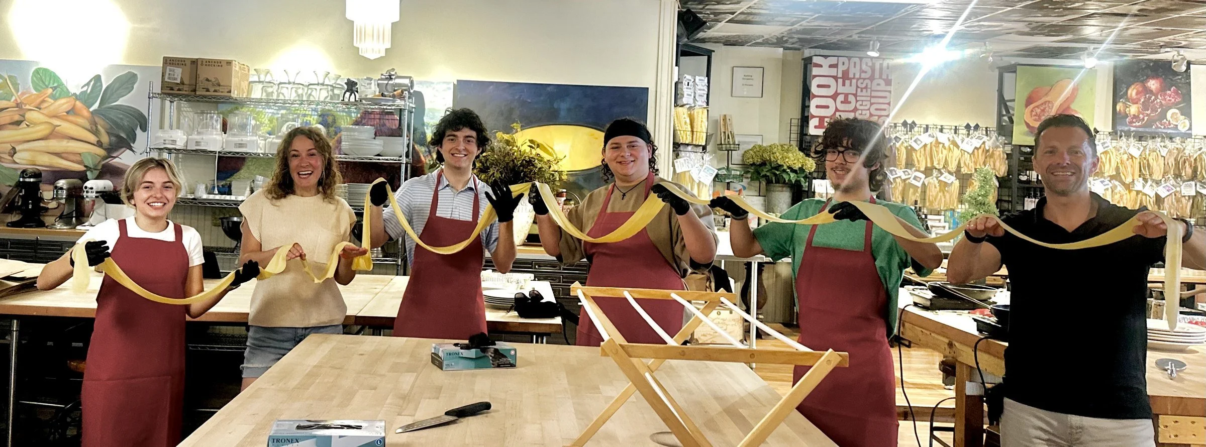 The Mudrey family stretching fresh pasta together at The Local Epicurean