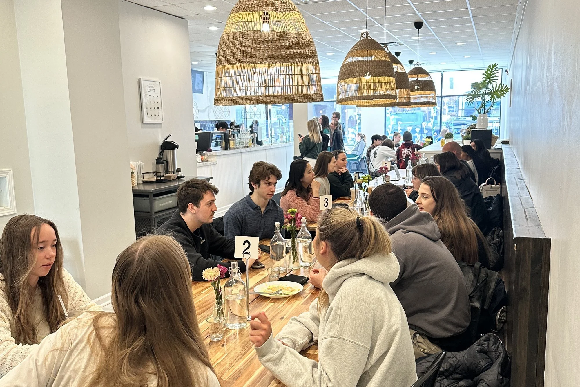 A full house at the long table inside For Crêpe Sake