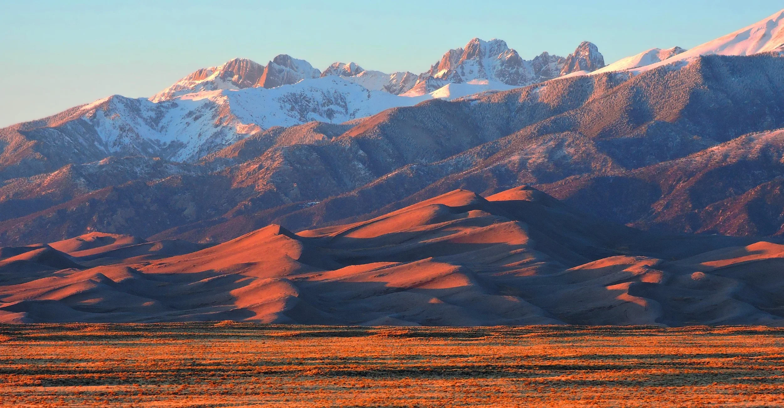 Warm alpenglow across Great Sand Dunes and the Sangre de Cristo Mountains