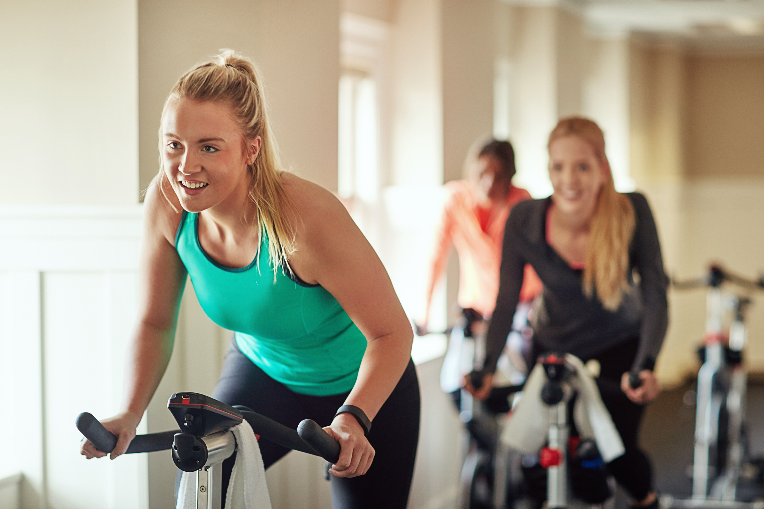 Friends participating in an indoor cycling class