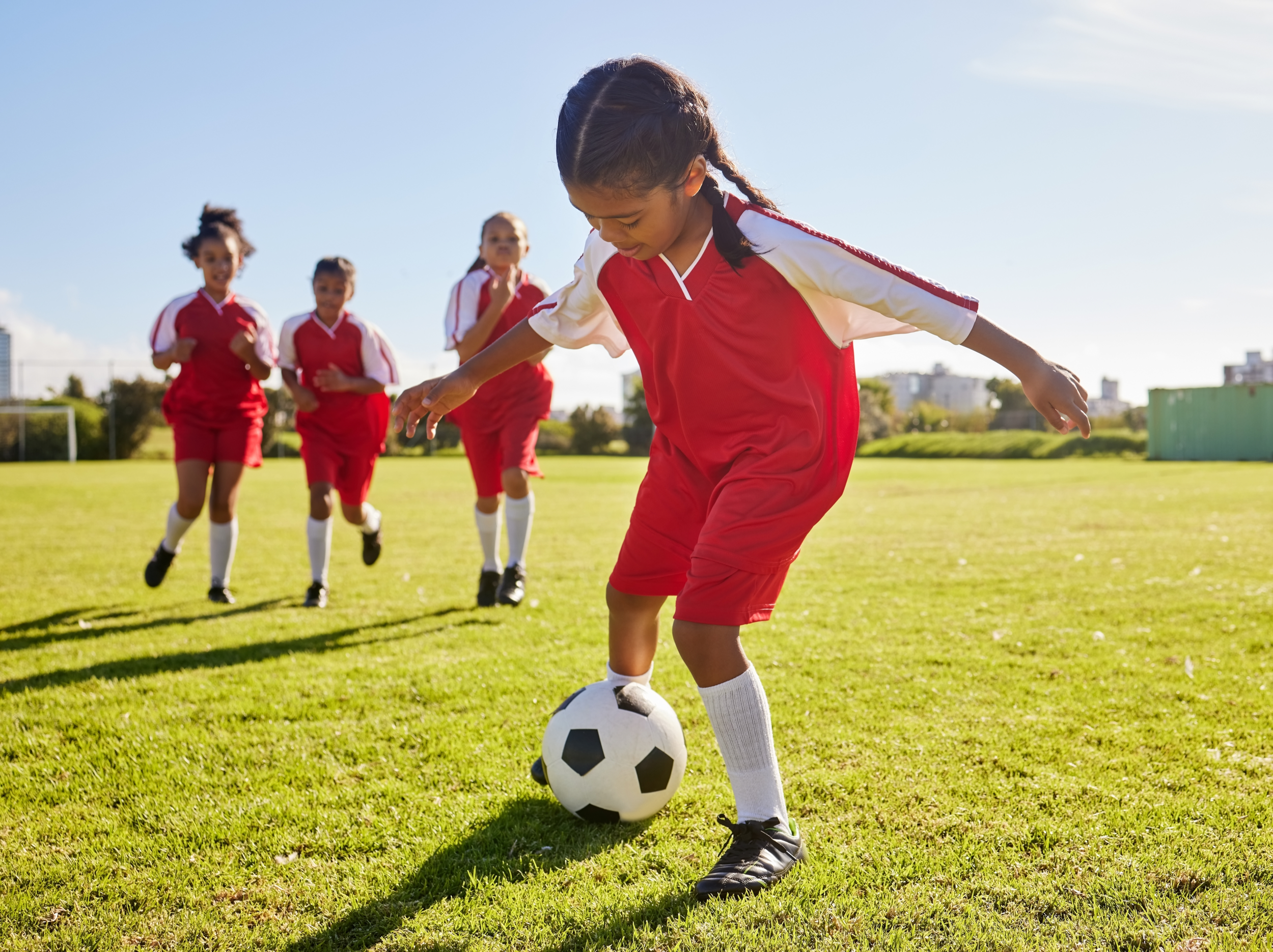 Young soccer player practicing with teammates on a field