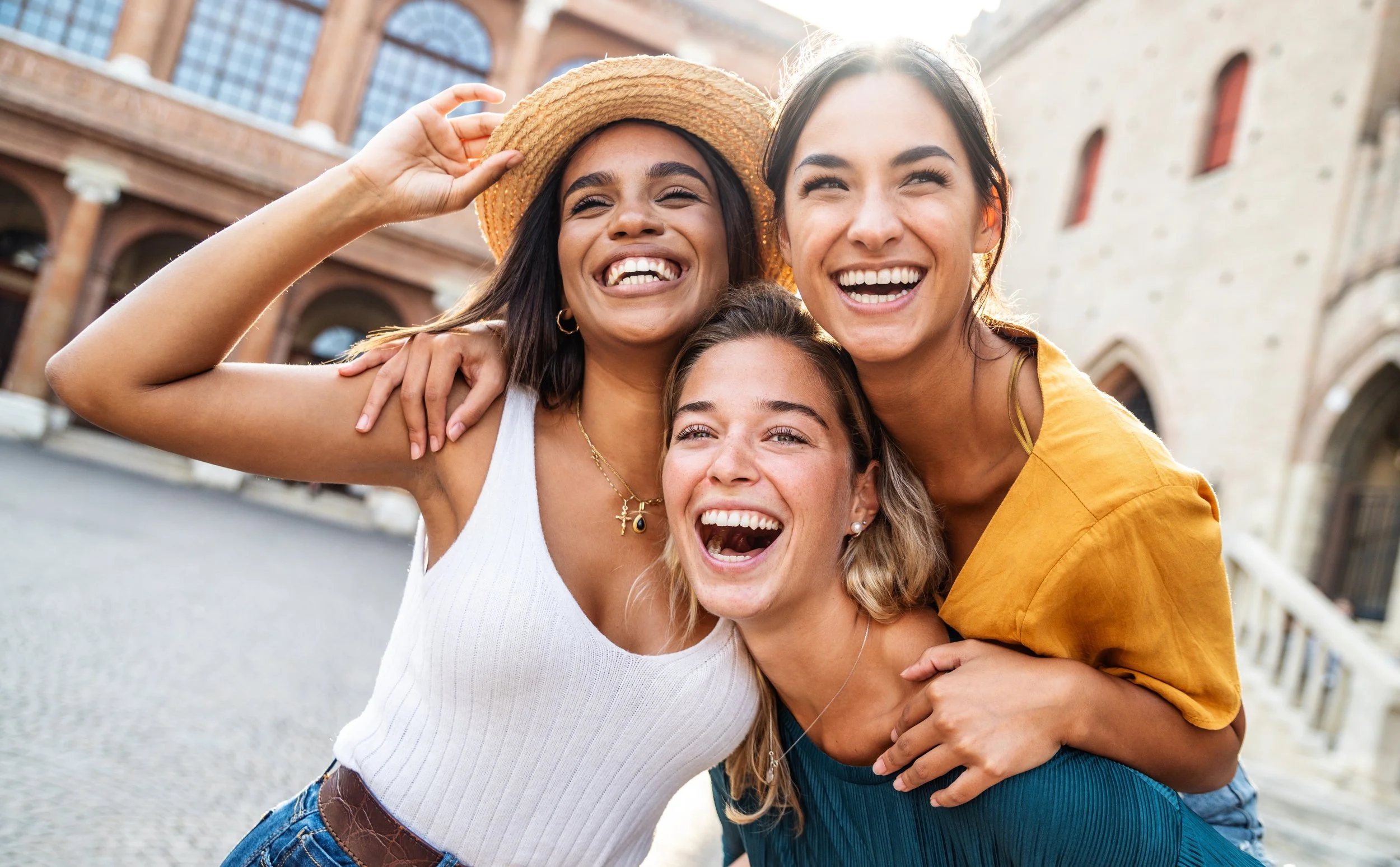 Three close friends smiling together