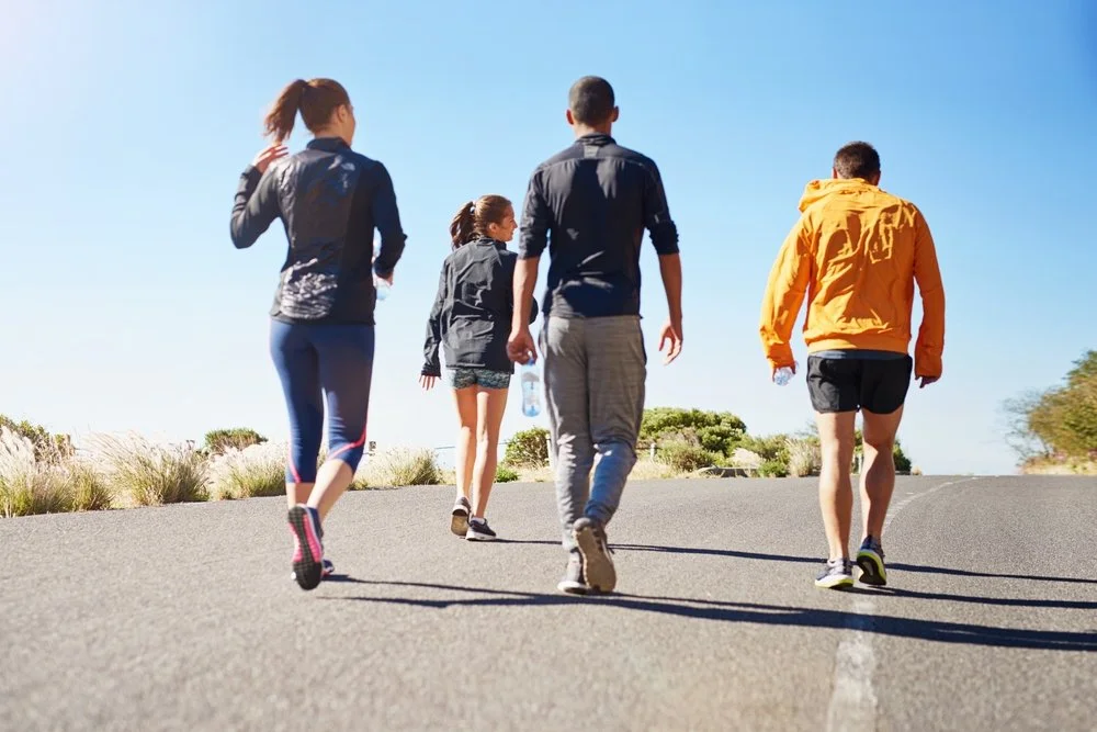 Friends walking and running together outdoors