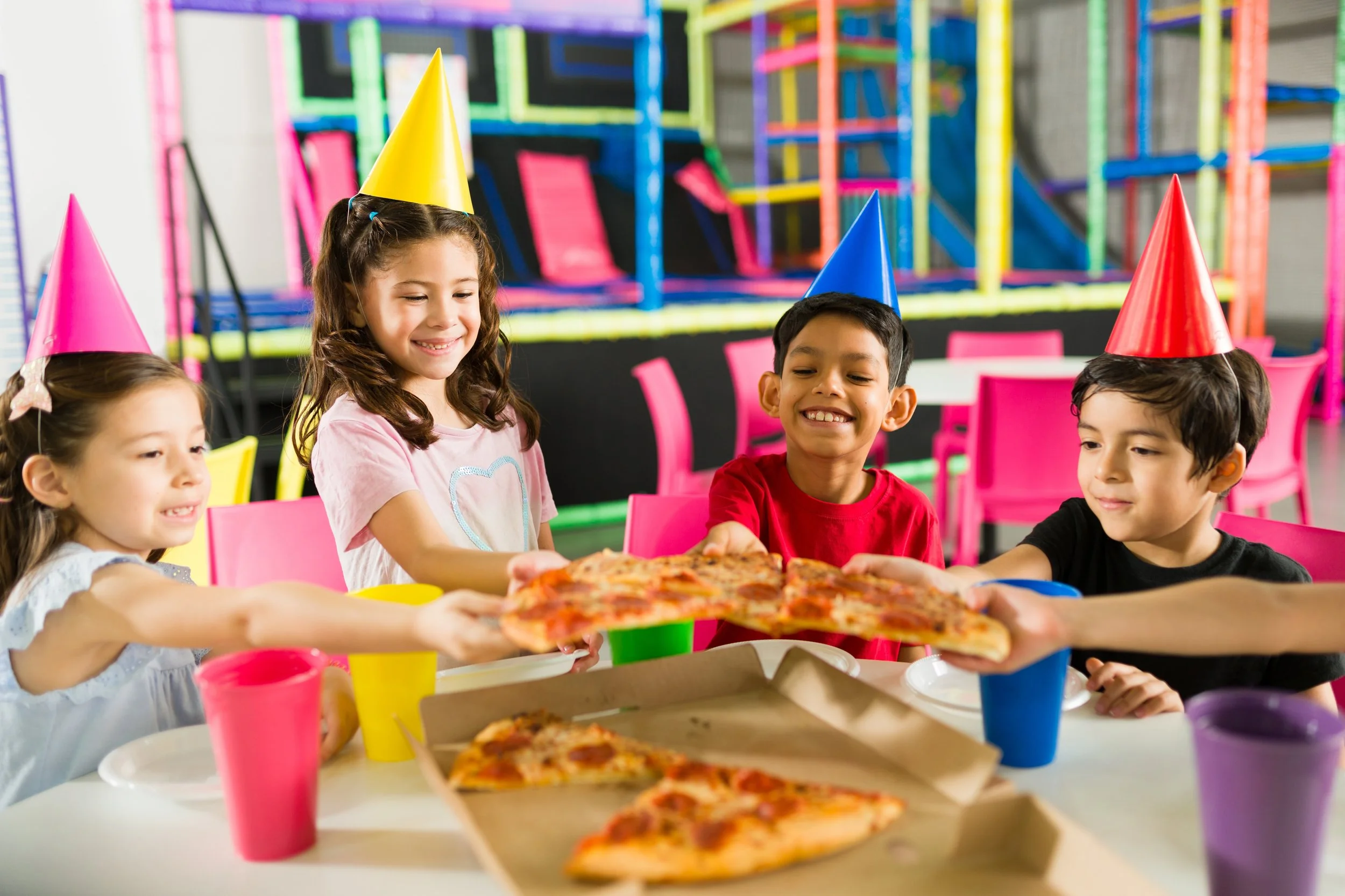 Children sharing pizza at a team birthday party