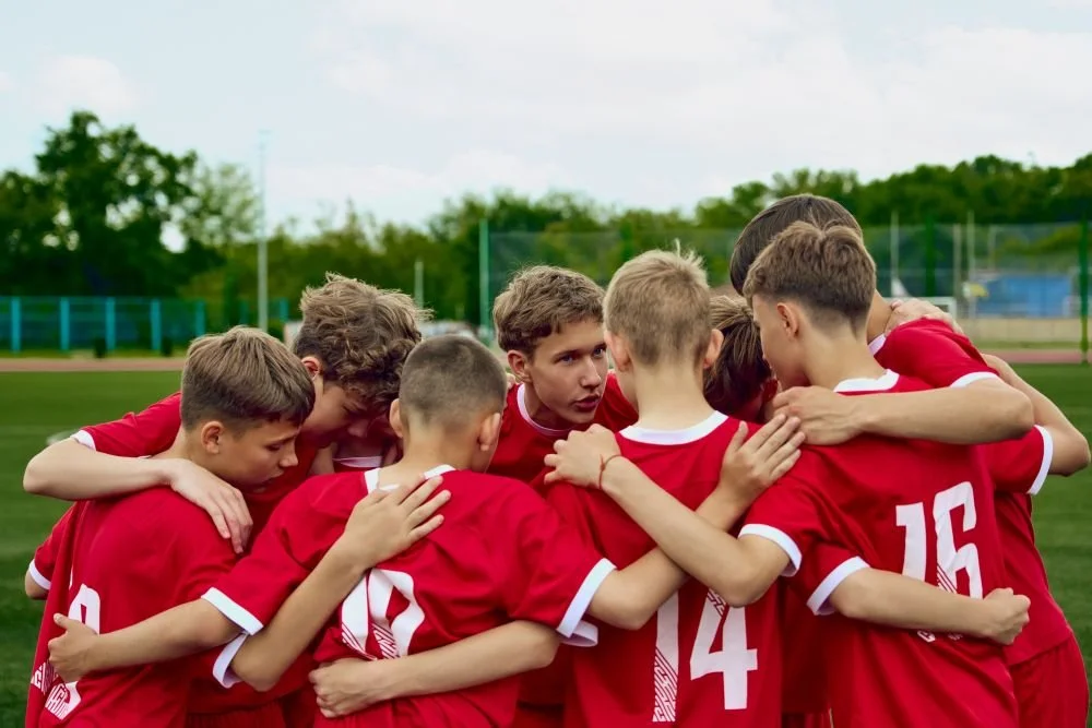 Youth soccer team gathered in a huddle