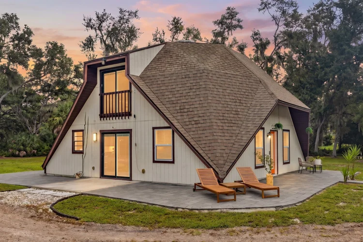 Twilight side exterior view of a geodesic dome home