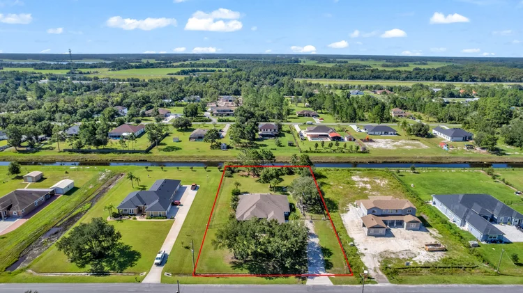 Aerial view of a vacant lot with property lines highlighted