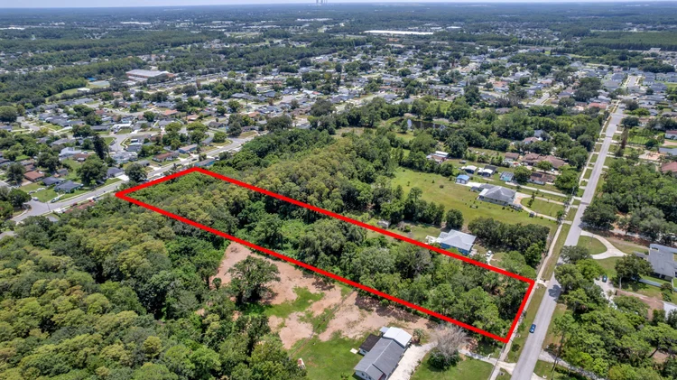Aerial view of a vacant lot with property lines highlighted