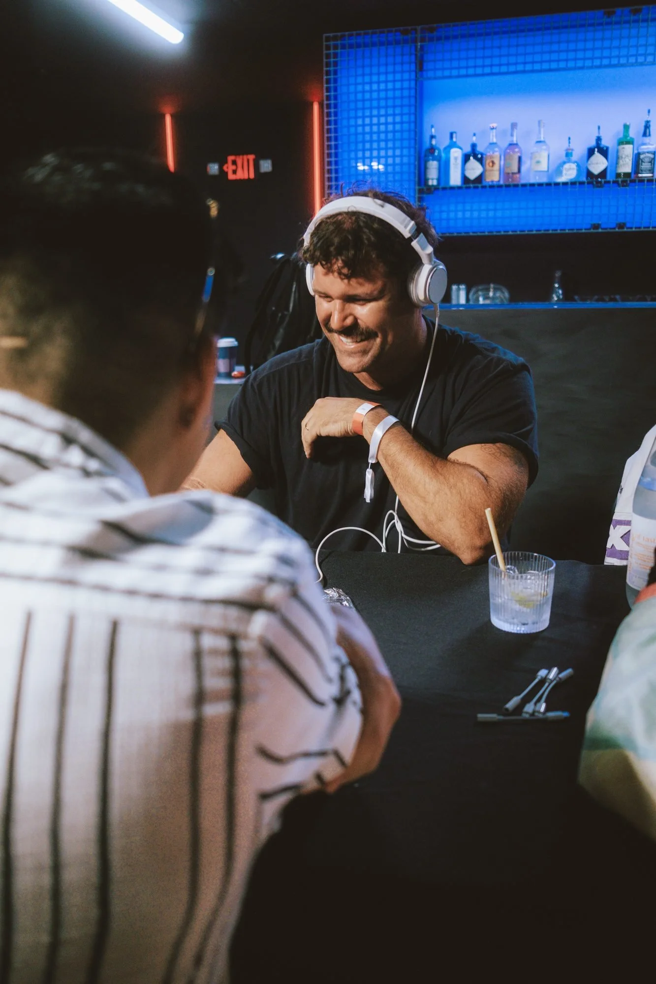 An artist playing a track for an A&R at Demo Drop