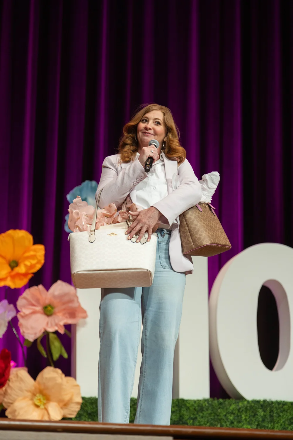 A host sharing a giveaway with the MORE 2025 audience