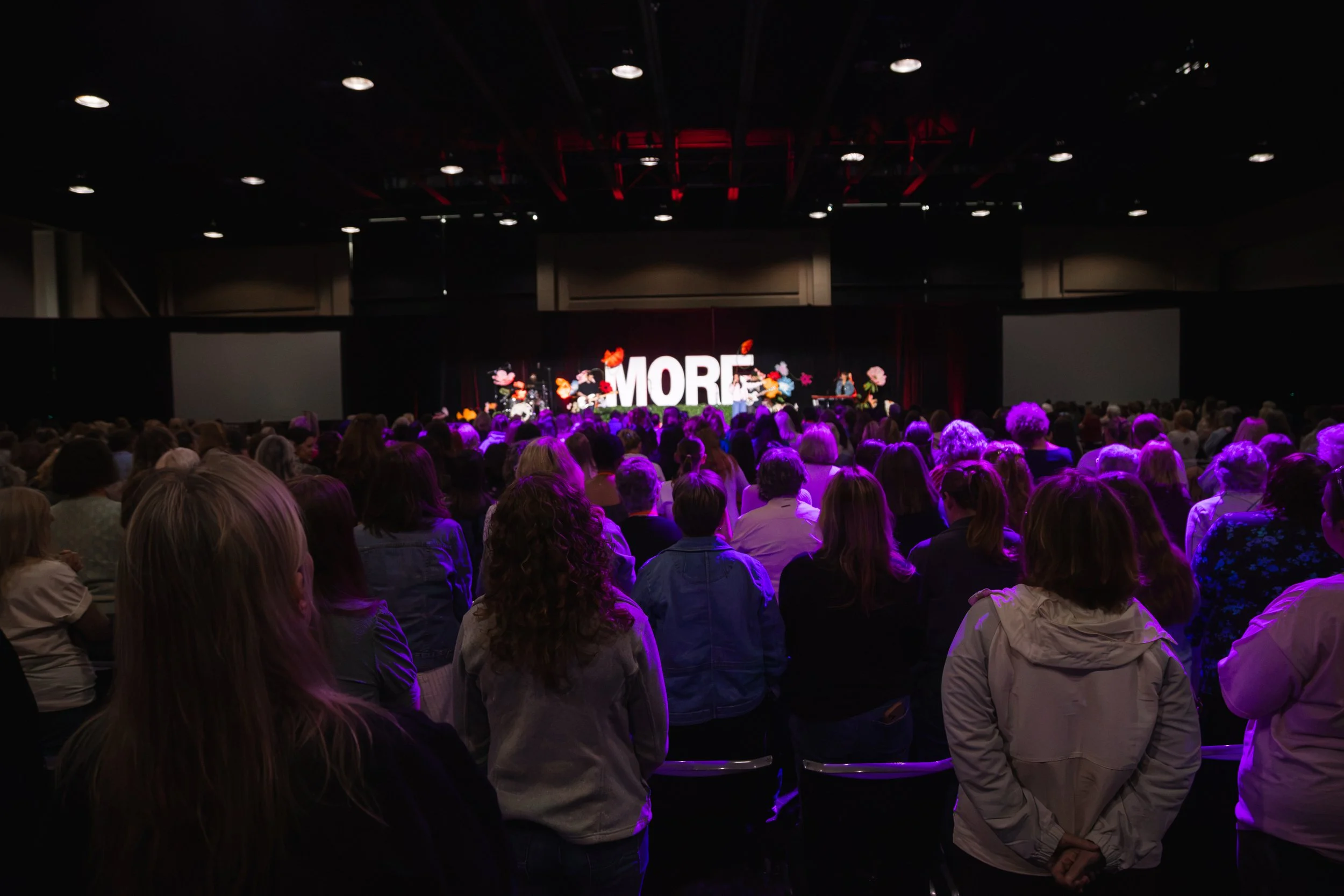 Audience watching musicians and speakers on the MORE Women’s Conference stage