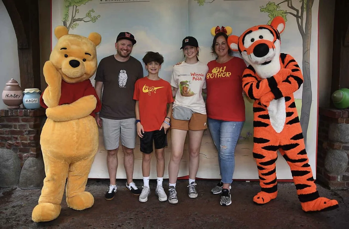 Celeste Woodside and her family visiting Magic Kingdom at Walt Disney World