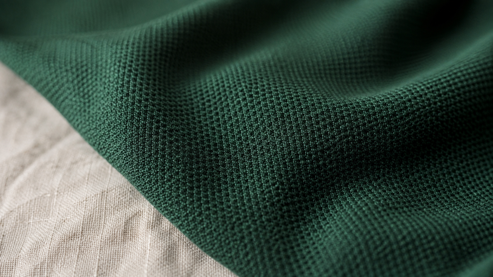 Close-up of pique knit fabric showing the textured mesh surface structure used in polo shirt manufacturing