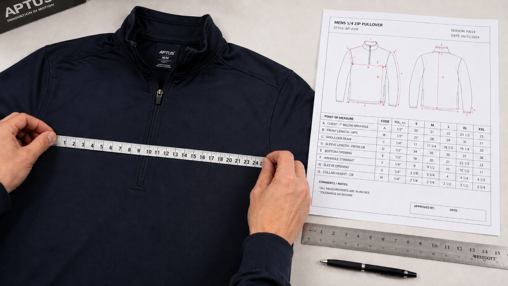 Garment sample being measured against a graded spec sheet with tape measure and technical ruler visible on a light surface