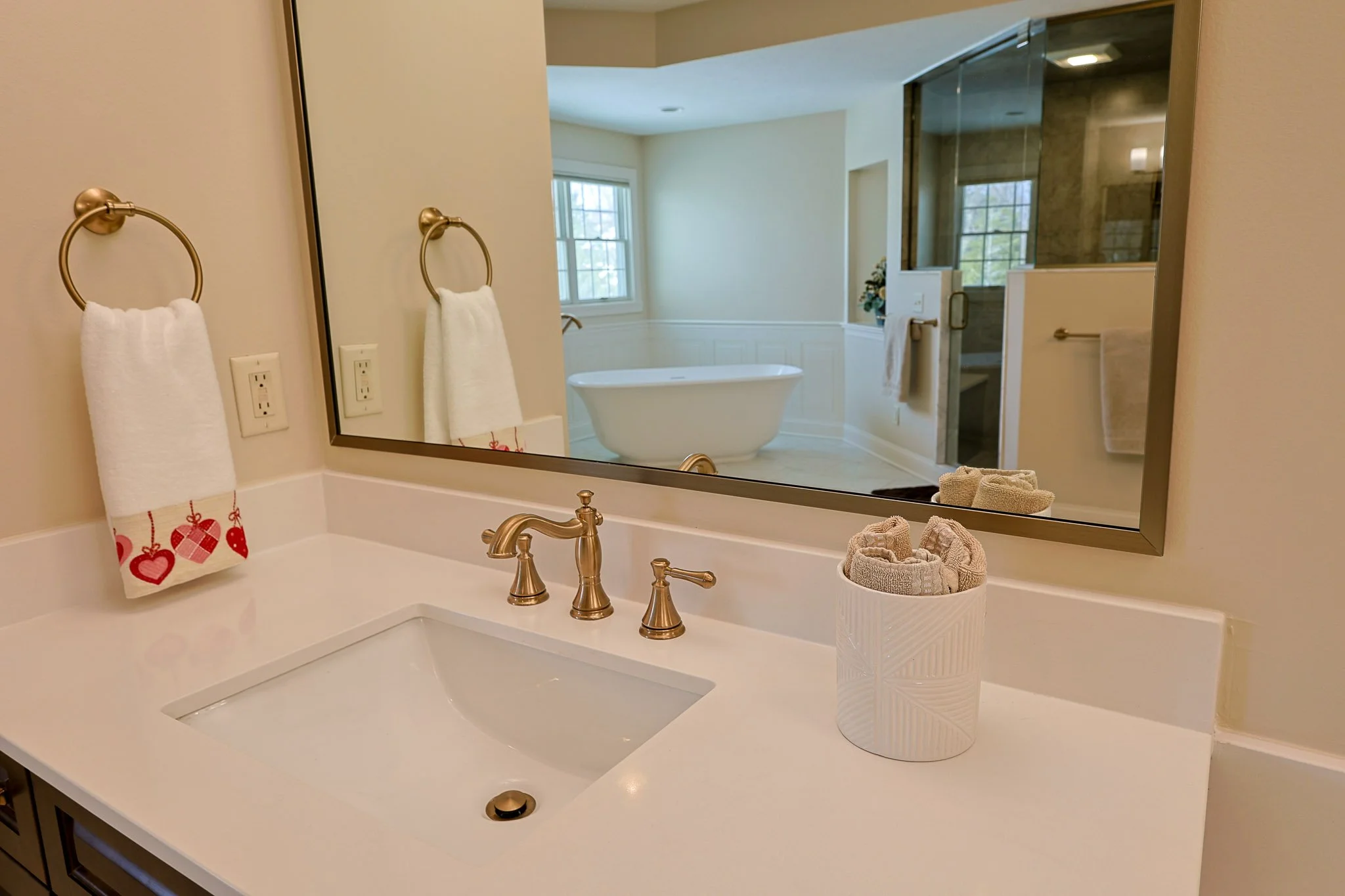 Remodeled bathroom with freestanding tub, tiled shower, and brushed-gold fixtures near Indianapolis