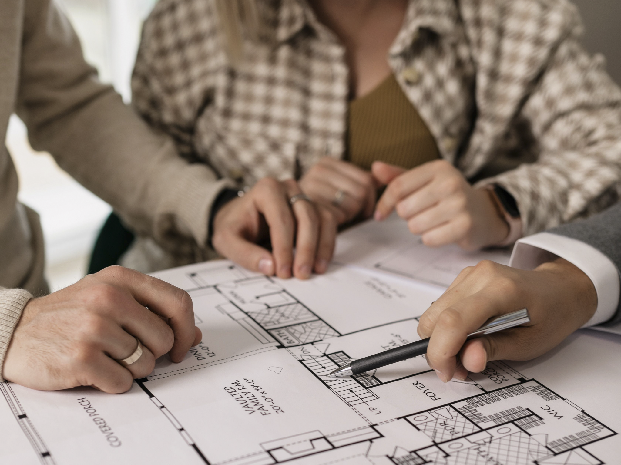 Homeowners reviewing remodeling floor plans with an ISI Construction project manager