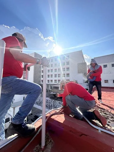 Equipo de trabajo sobre una azotea en ISSSTEP Puebla.