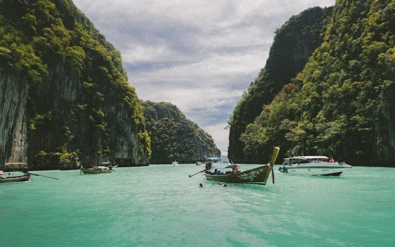 Longtail boats in the emerald lagoon of Phi Phi Islands, Thailand