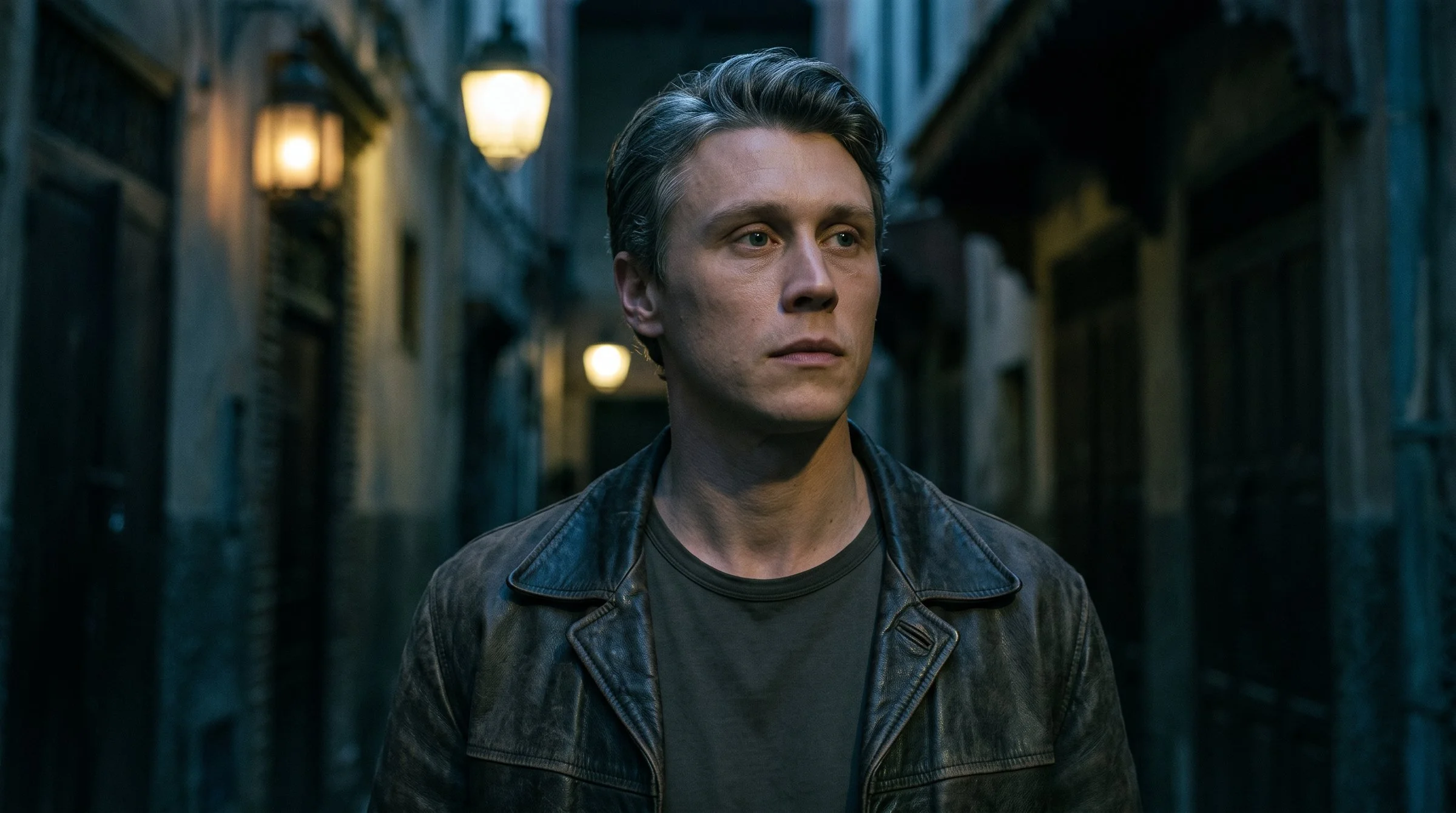 Stuart alone in a narrow medina lane at night