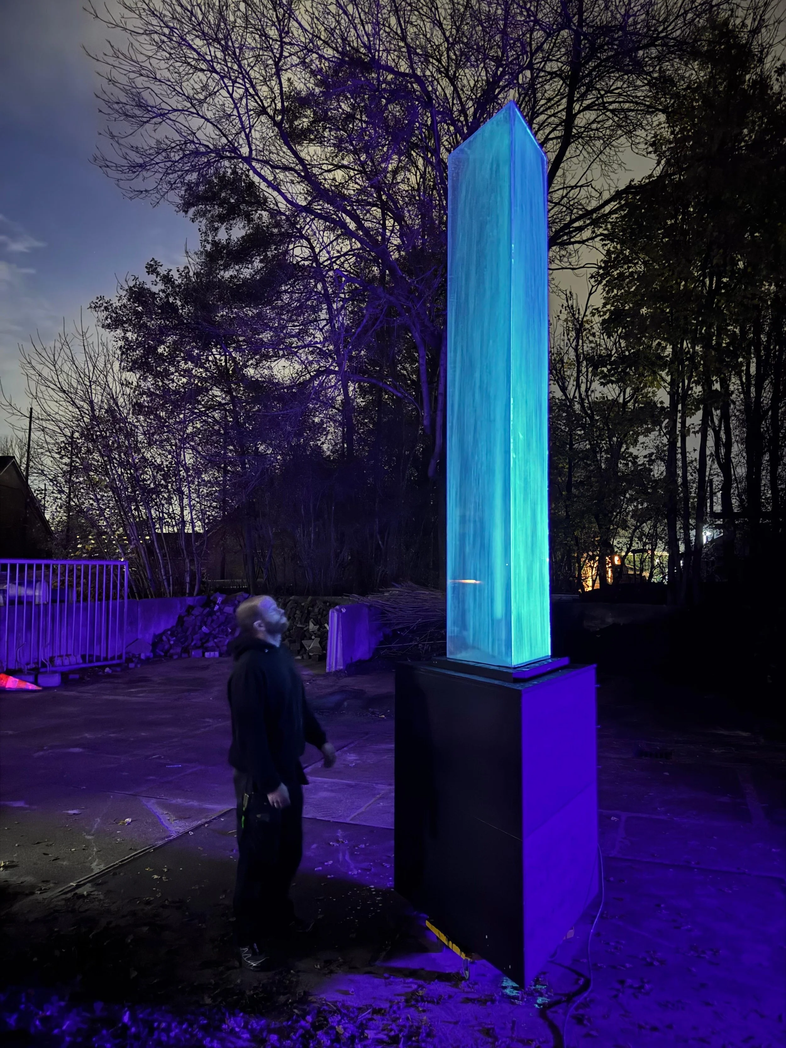 Bioluminescent Waterjets 2025 — illuminated water column outdoors at dusk