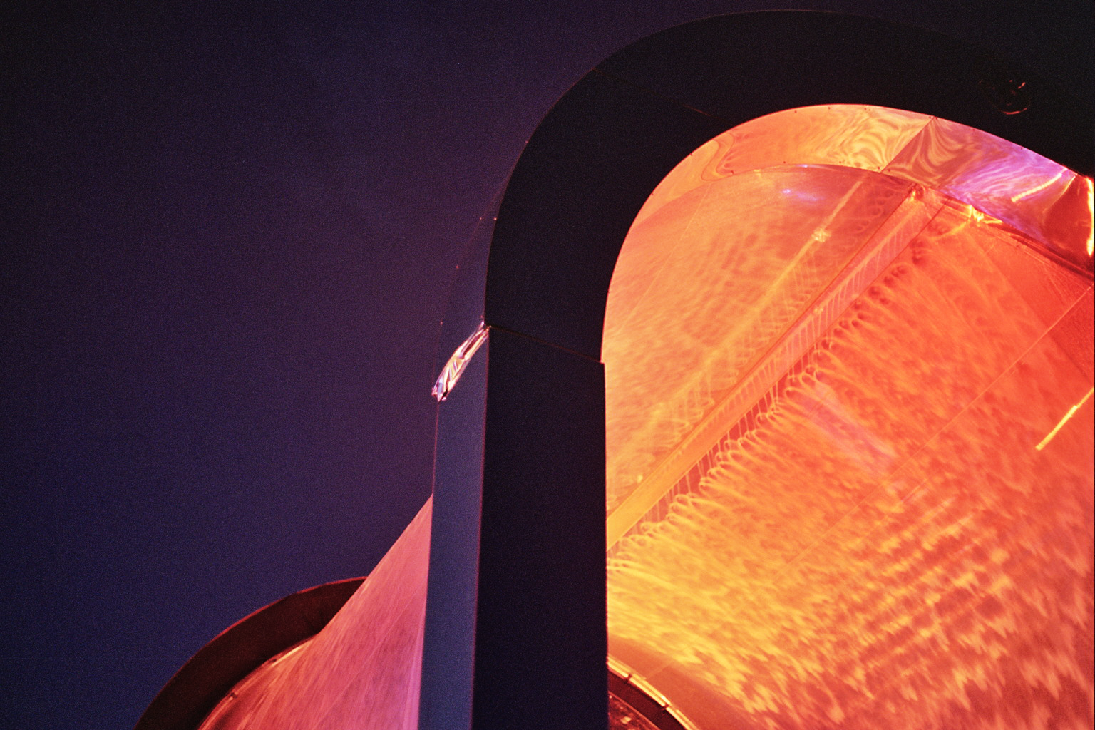 Warm light and moving water beneath the Watergate arch in 2024