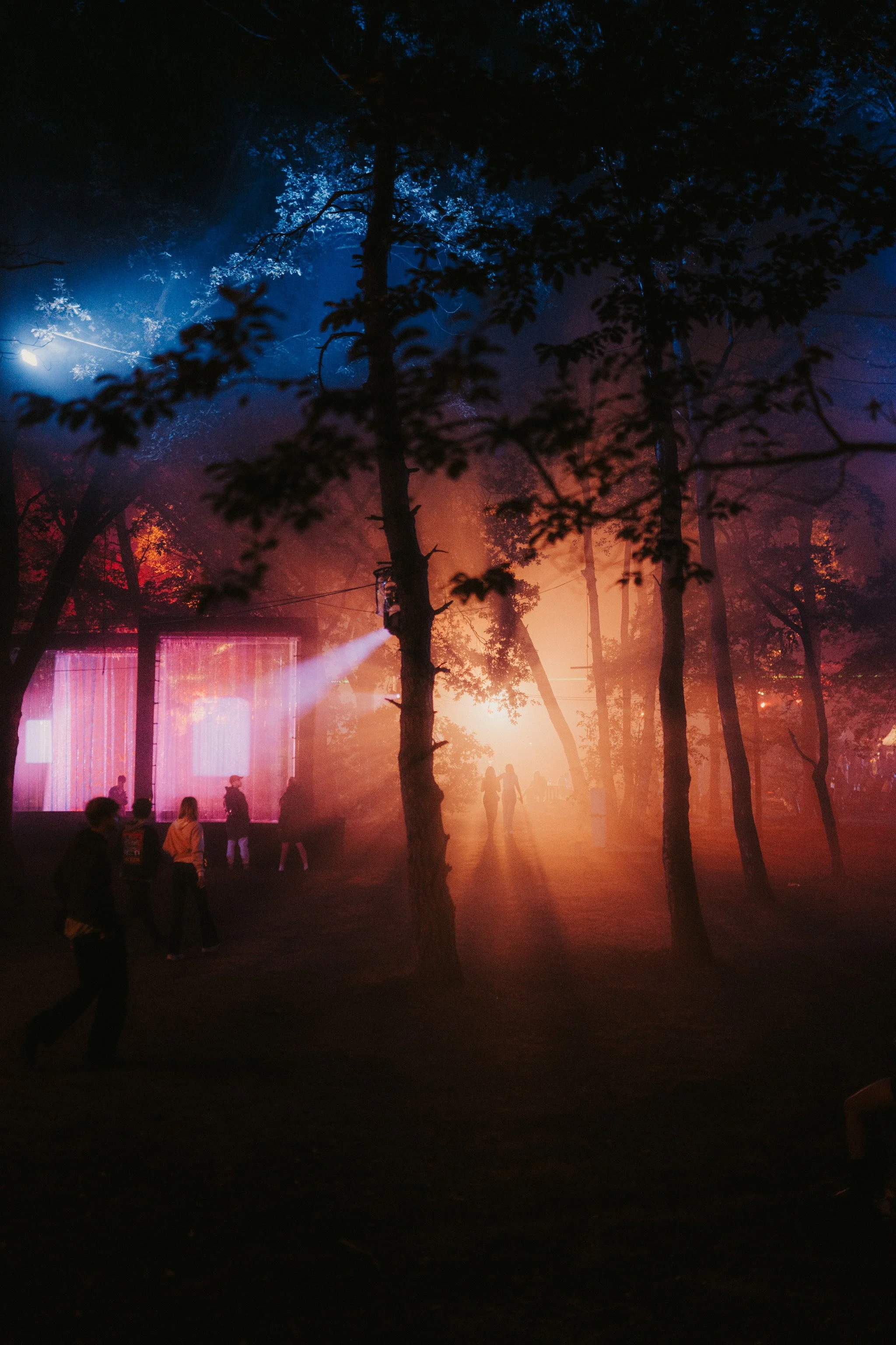 Waterfall at Awakenings Summer Festival 2024, glowing in a forest at night