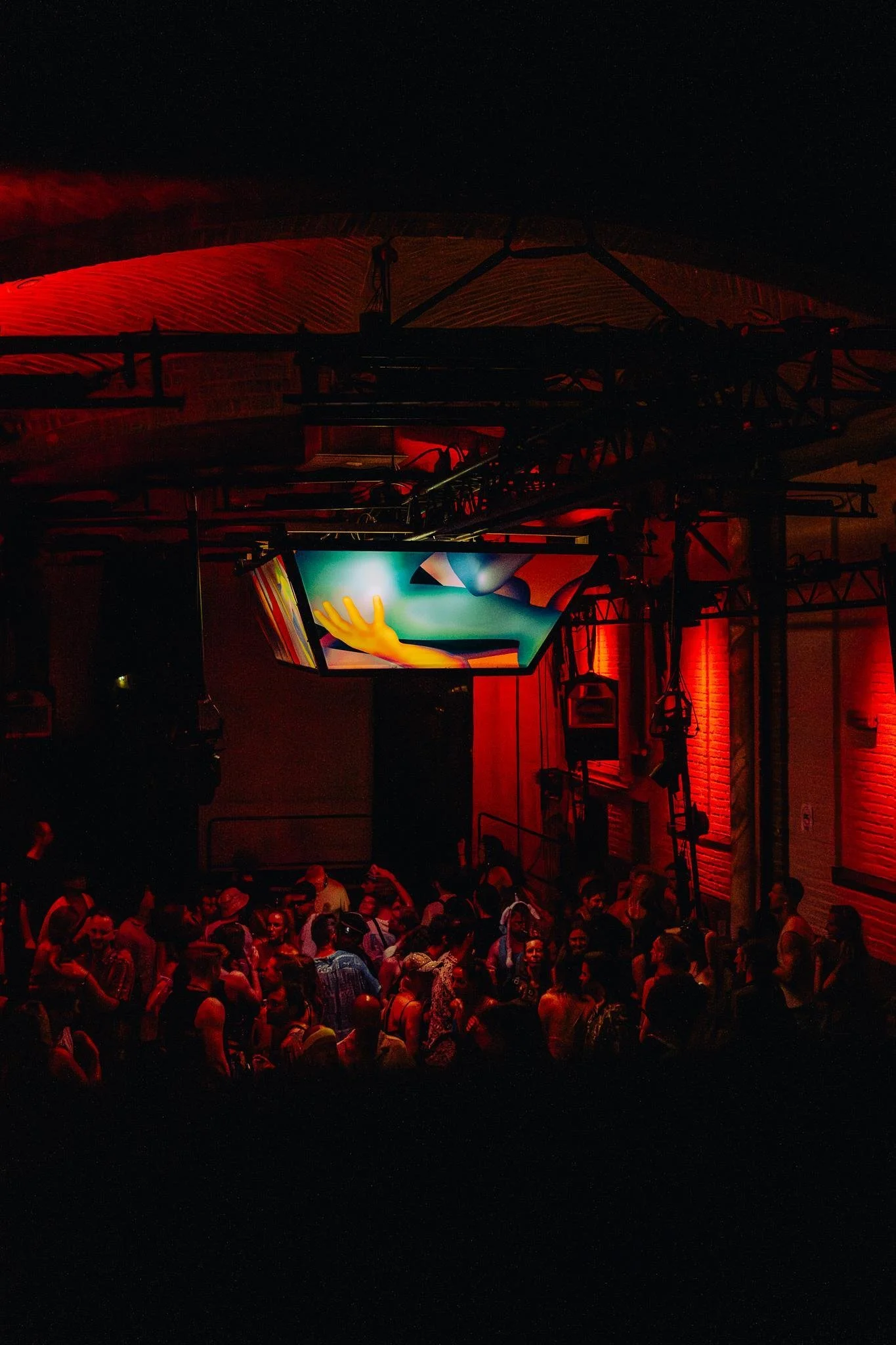 Bosburcht Summer 2025: the audience beneath a light object in the red-lit hall