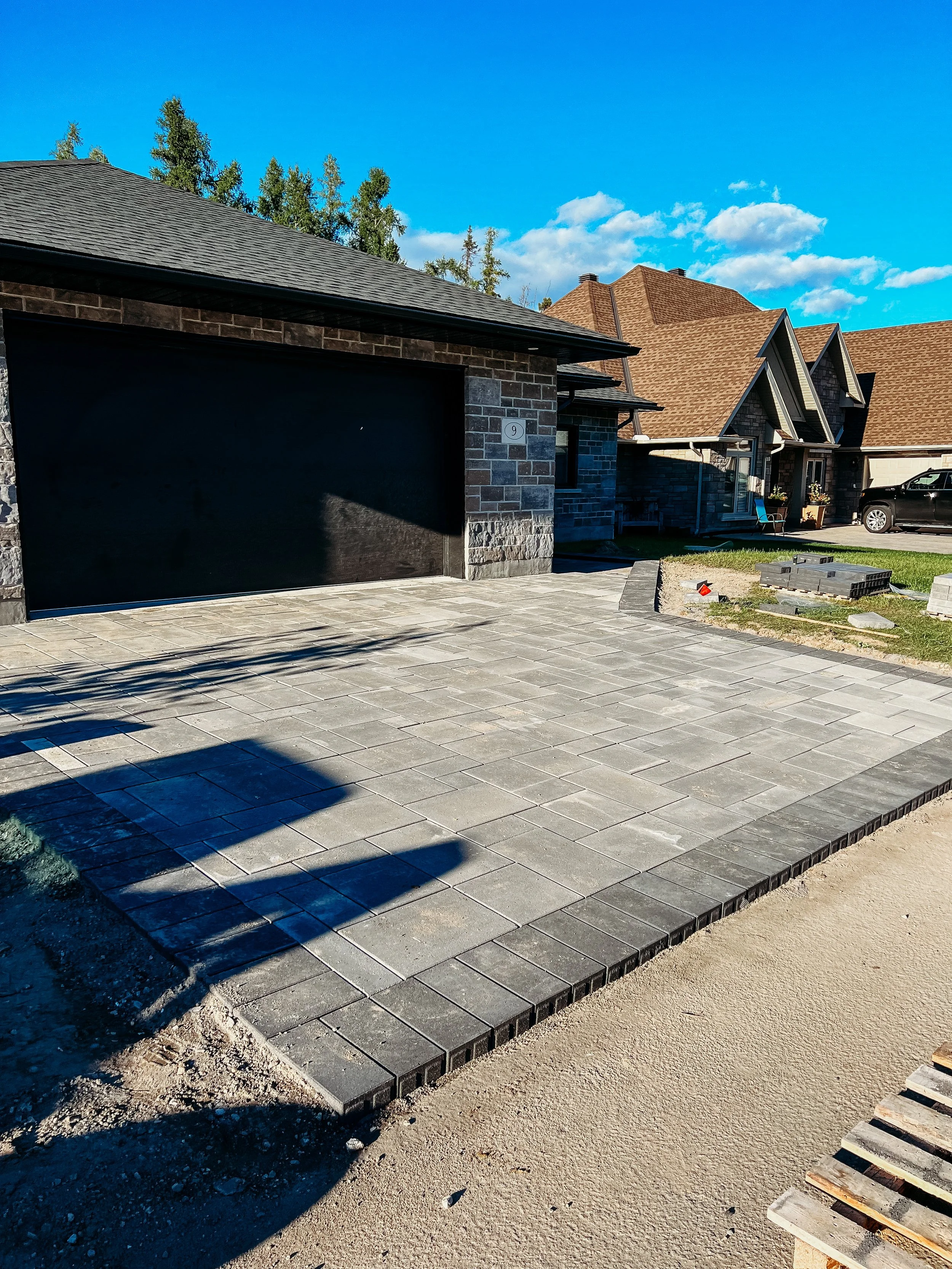 Finished interlock driveway with clean lines and base preparation