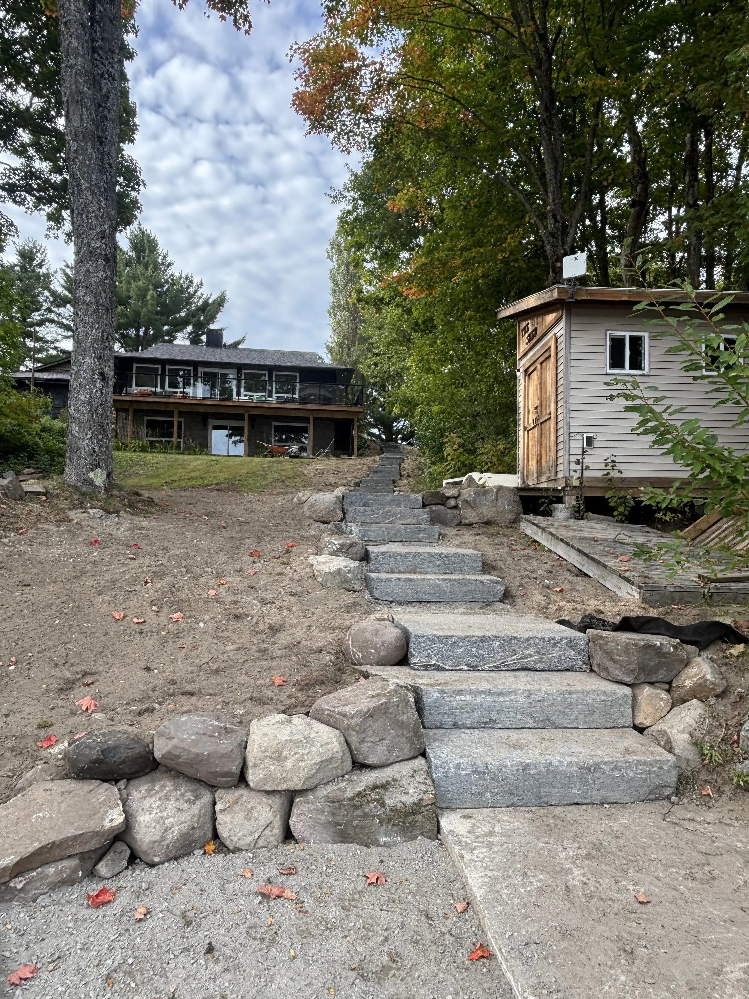 Large stone staircase under construction with elevation change in Muskoka