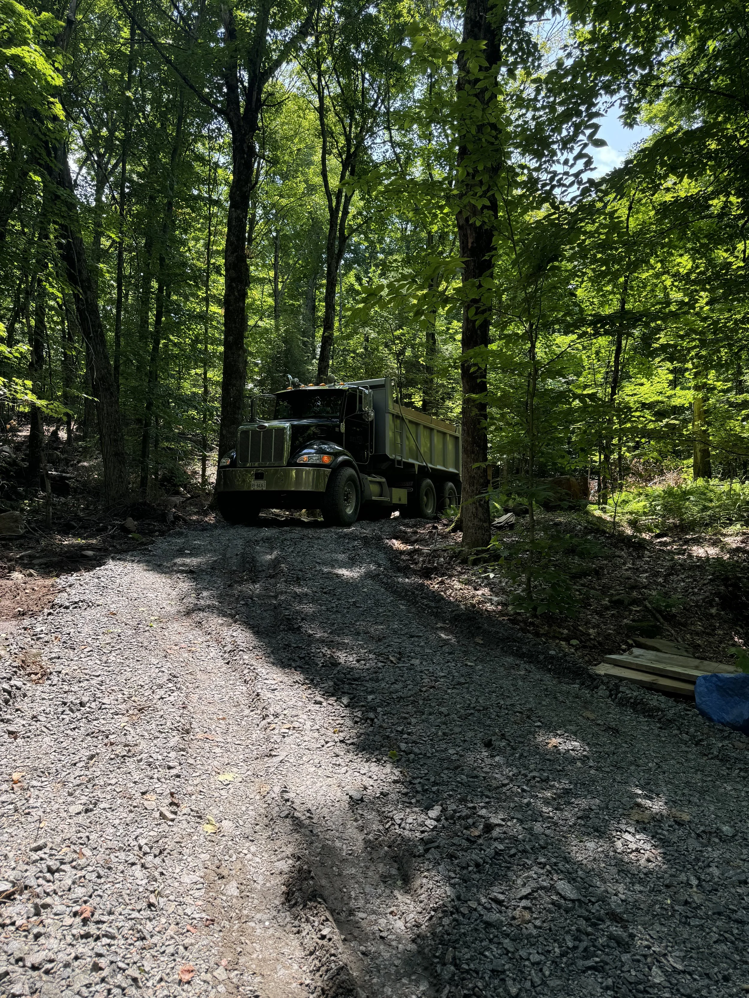 Dump truck working on a new access road install