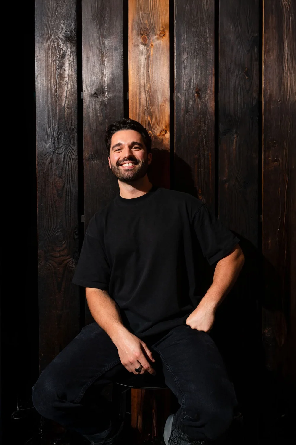 James Turner, seated against a dark timber wall.