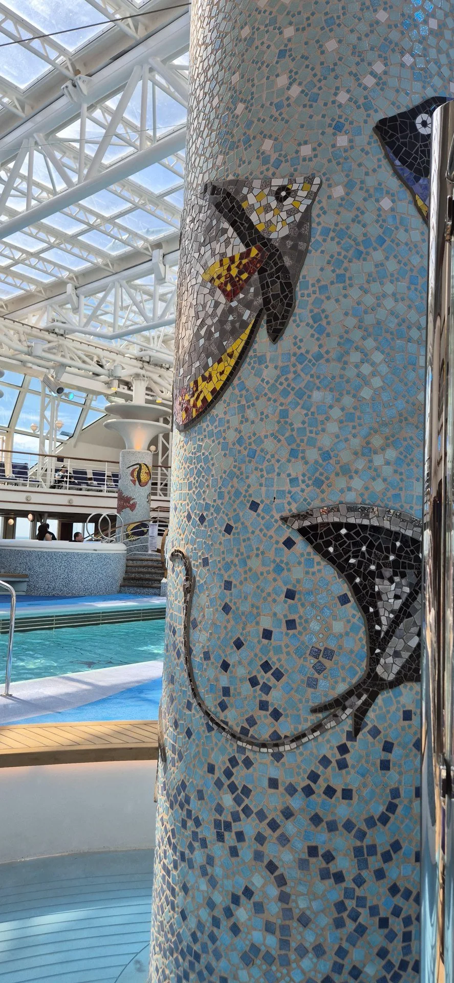Mosaic column beside an indoor cruise ship pool.