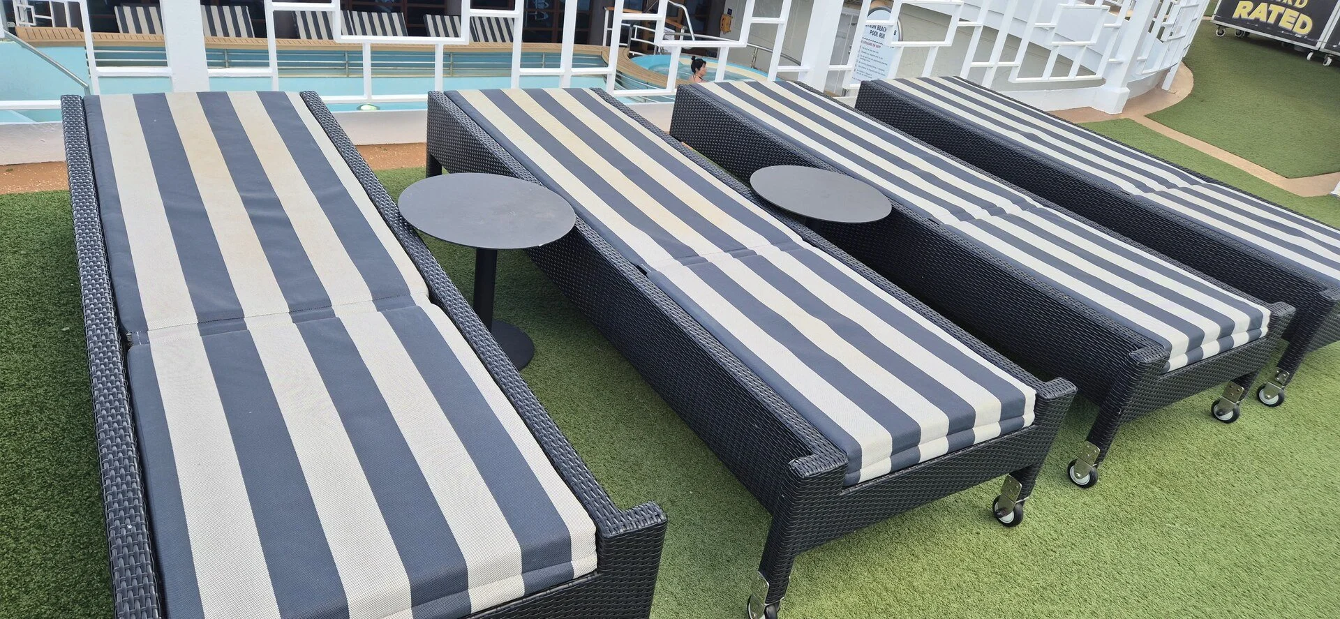 Striped loungers arranged on a cruise ship deck.