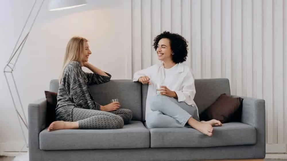 Two women sitting together in conversation on a couch