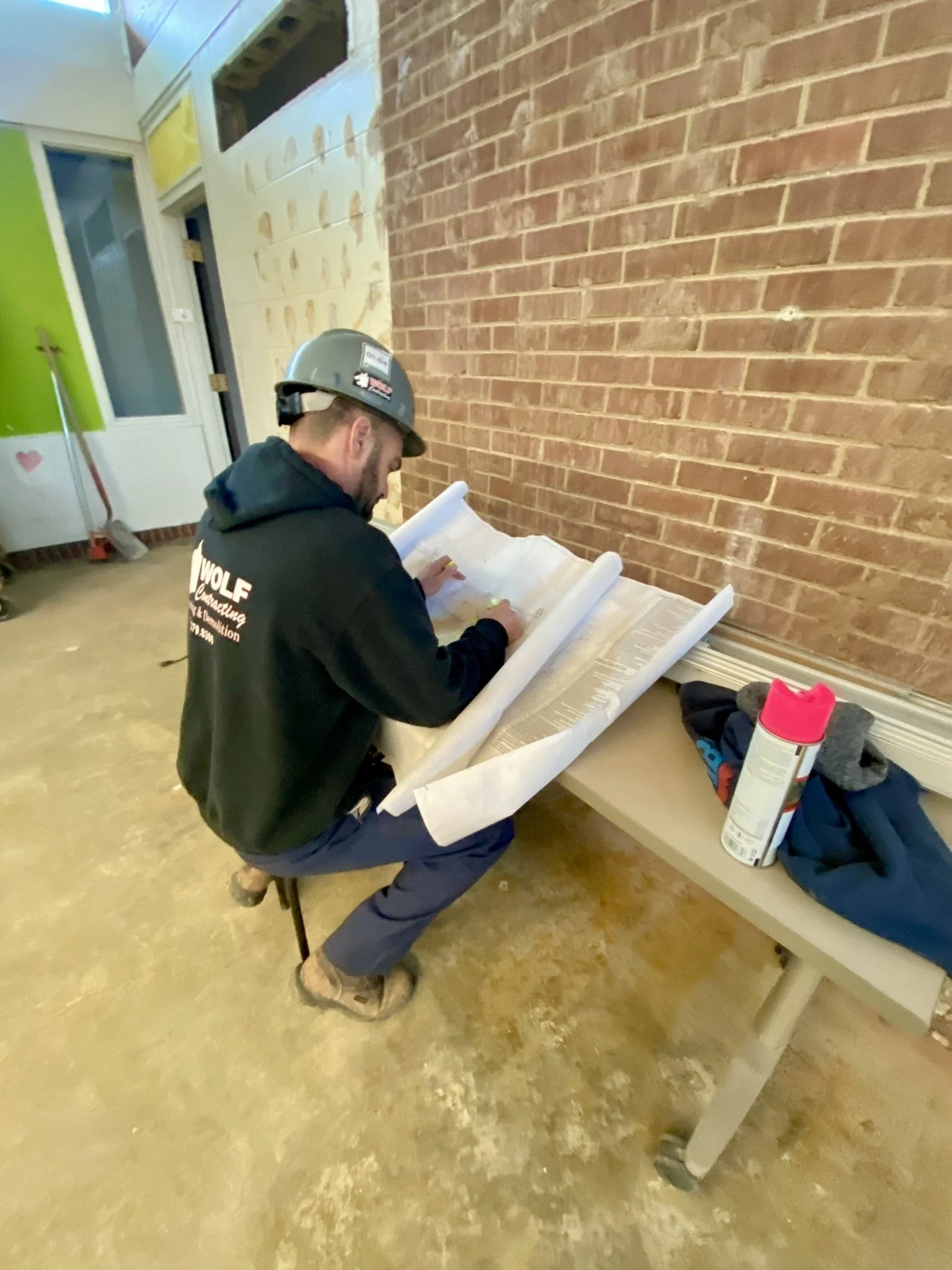 Wolf Contracting supervisor reviewing project plans
