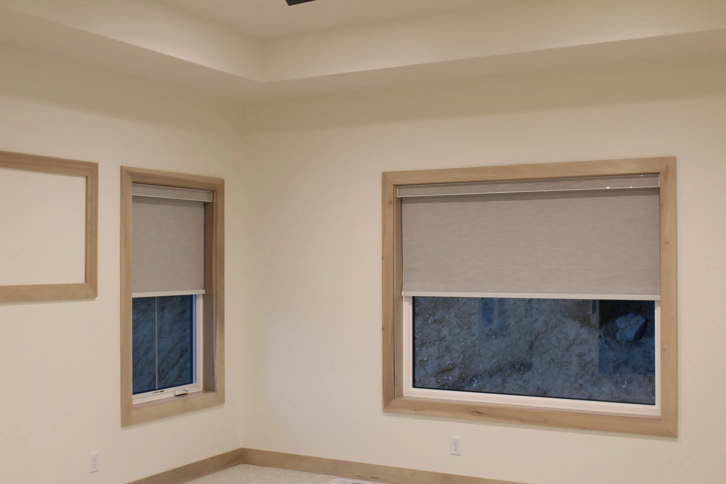 Roller blinds installed in a bright living space