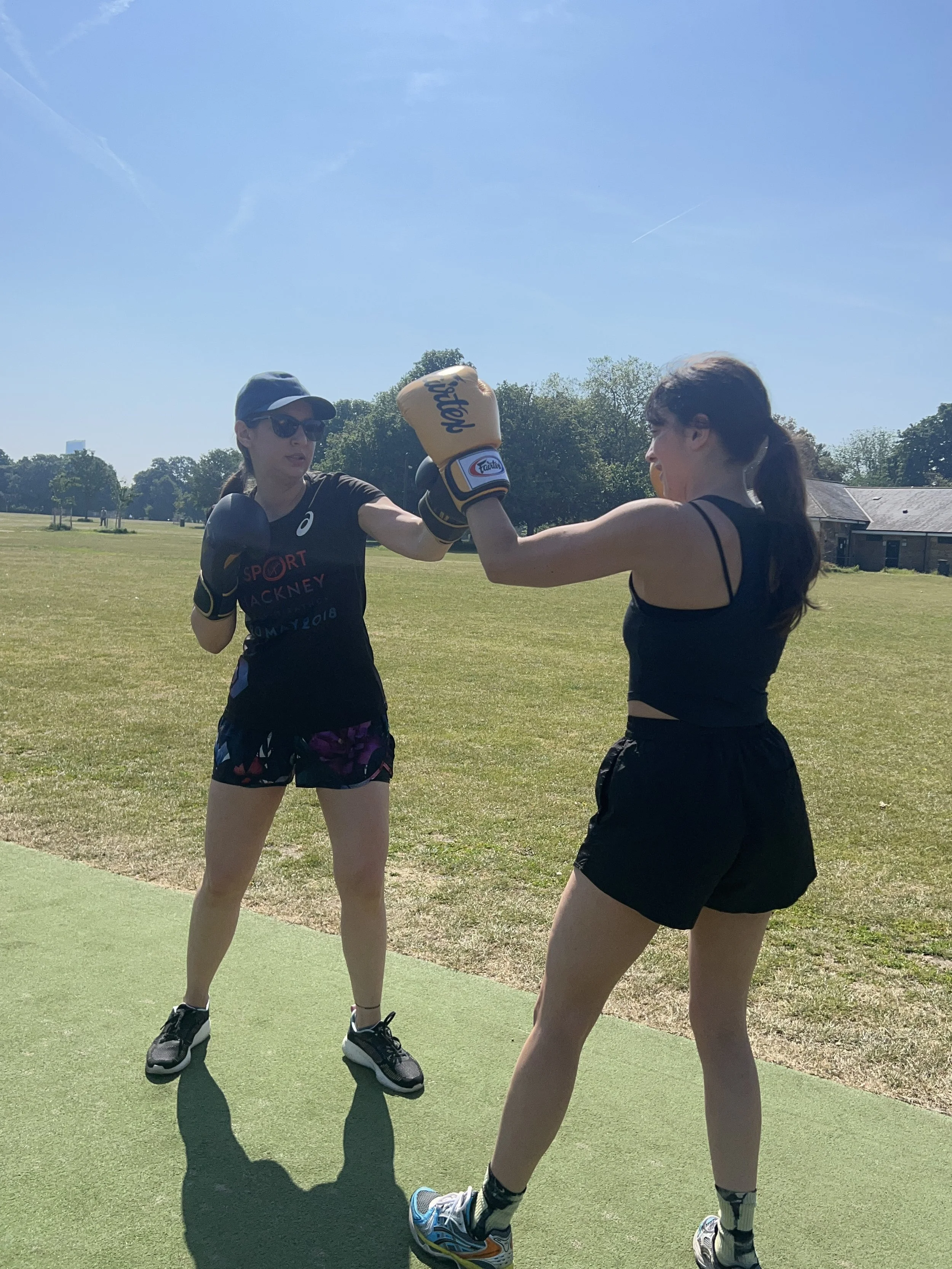 Coach-led outdoor boxing padwork session in Victoria Park with calm, beginner-friendly instruction at The MAW Studios