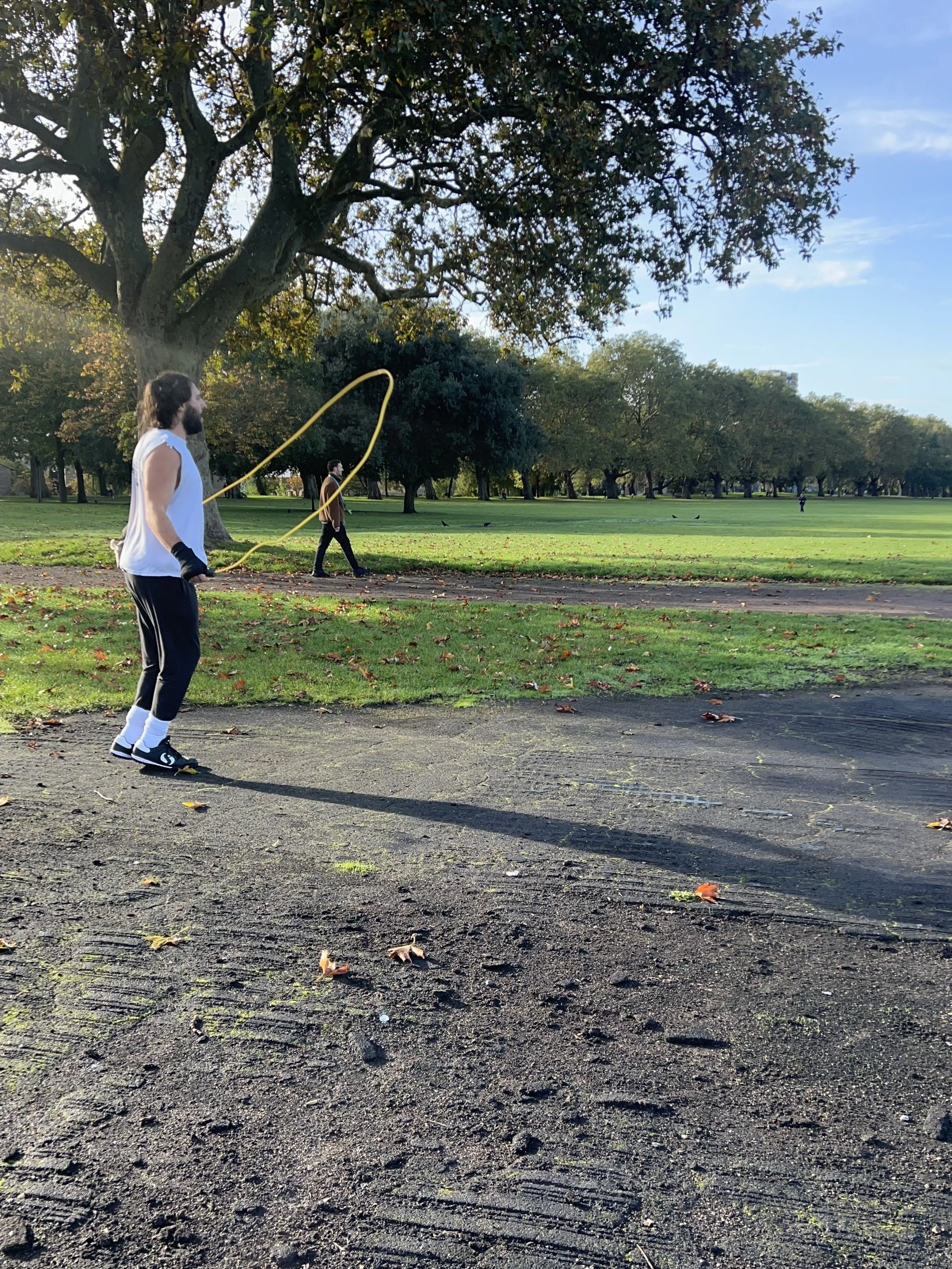 Outdoor training atmosphere in Victoria Park with skipping rope under a large tree