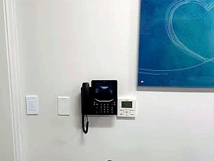 Wall-mounted phone installed in an office