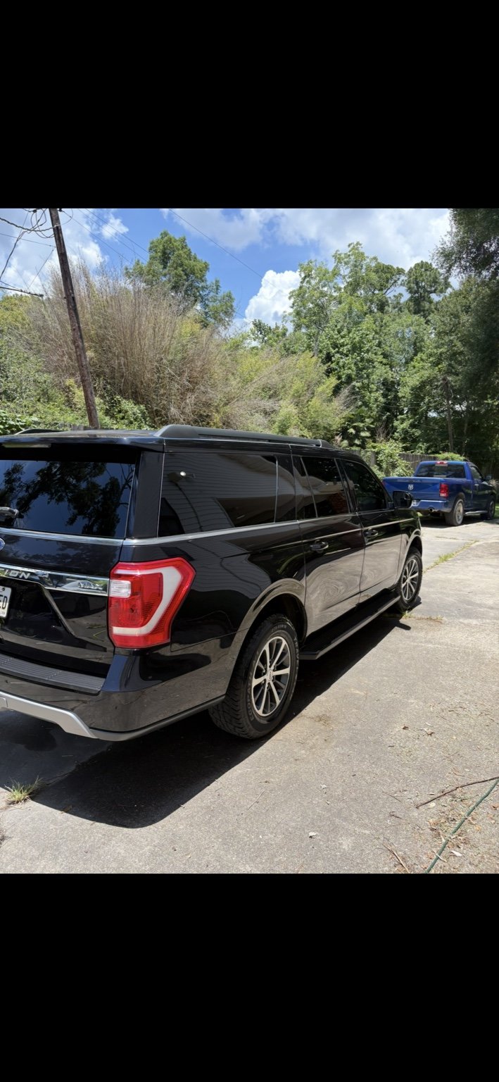 Glossy black SUV after exterior detailing by Polish Patrol