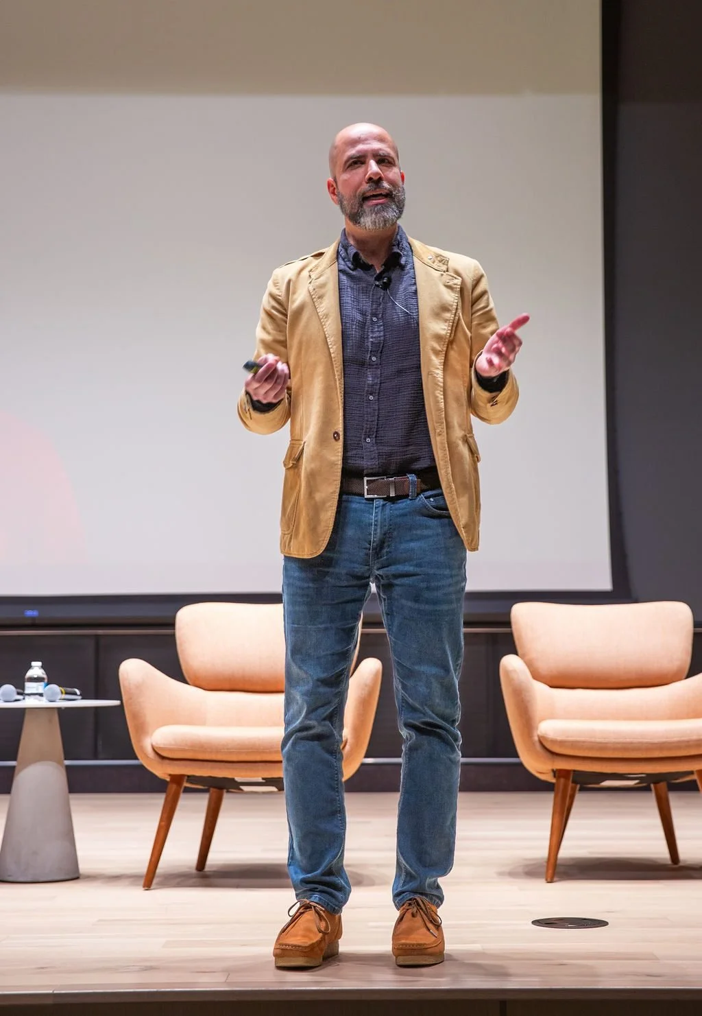 Nader Afzalan speaking on stage