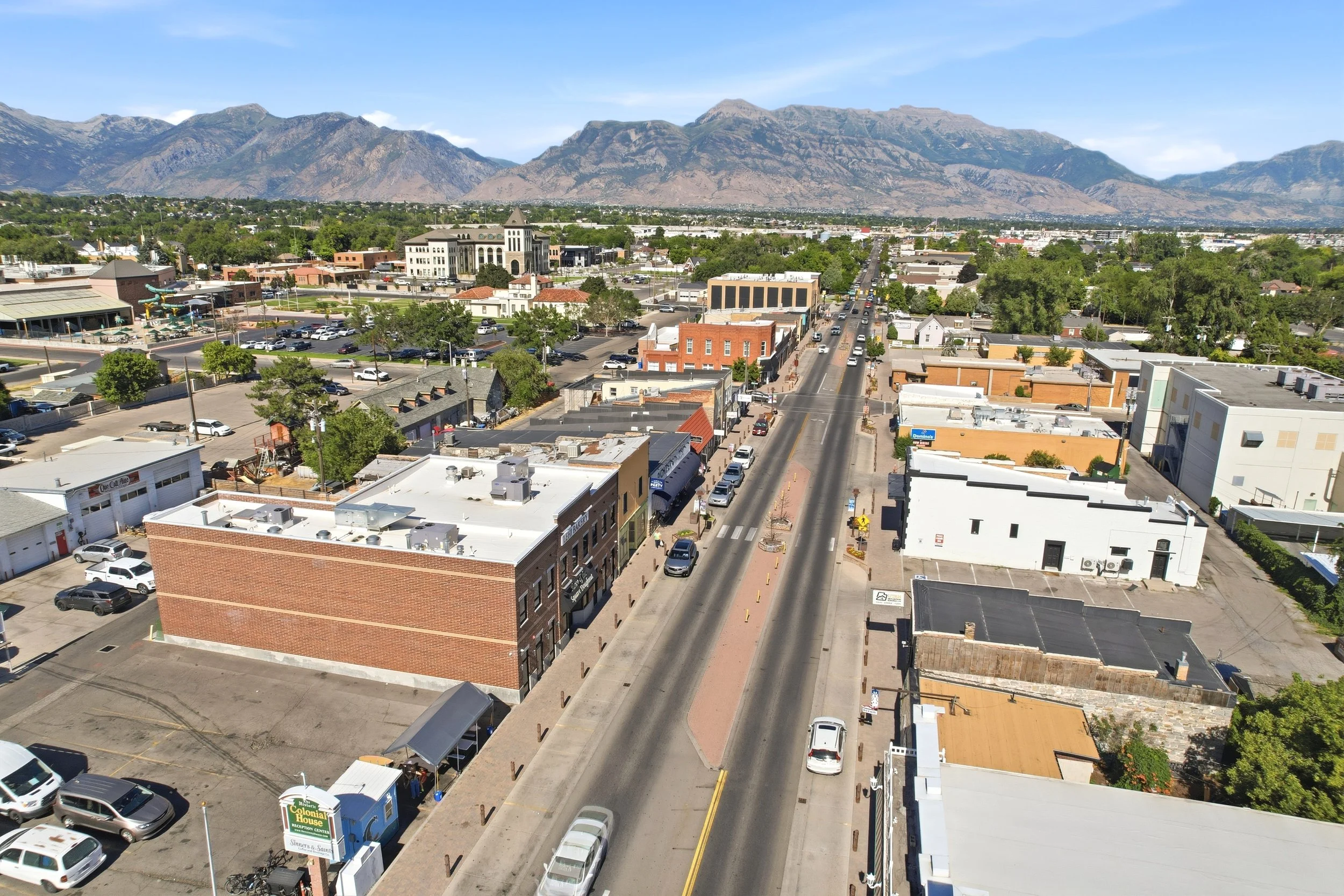 Aerial view of historic Main Street, established neighborhoods, and mountains in Lehi, Utah
