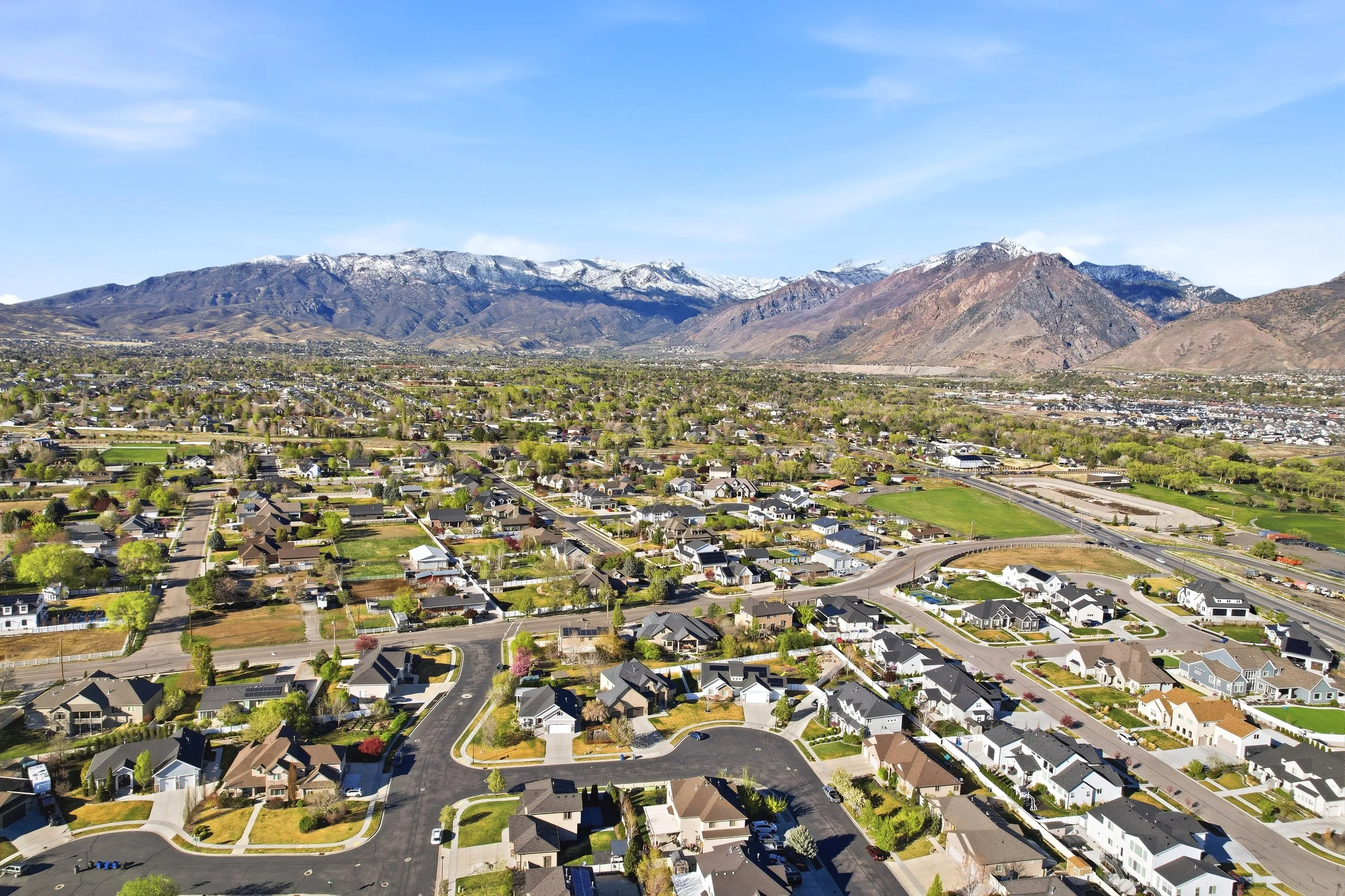 Aerial view of American Fork Utah neighborhoods beneath the Wasatch mountain range